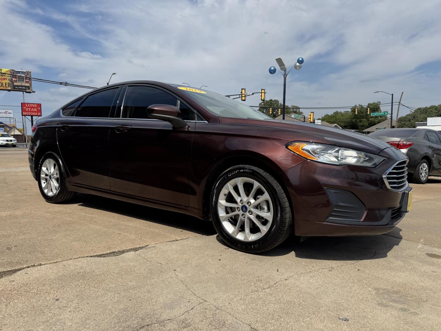2019 RED FORD FUSION SE SE (3FA6P0HD5KR) with an 1.5L engine, 6-Speed Automatic transmission, located at 5900 E. Lancaster Ave., Fort Worth, TX, 76112, (817) 457-5456, 0.000000, 0.000000 - The 2019 Ford Fusion SE delivers efficiency and comfort with its 1.5L EcoBoost engine offering up to 34 MPG highway. Features include Bluetooth, backup camera, alloy wheels, and seating for five. A reliable sedan with modern technology and great fuel economy - Photo#2