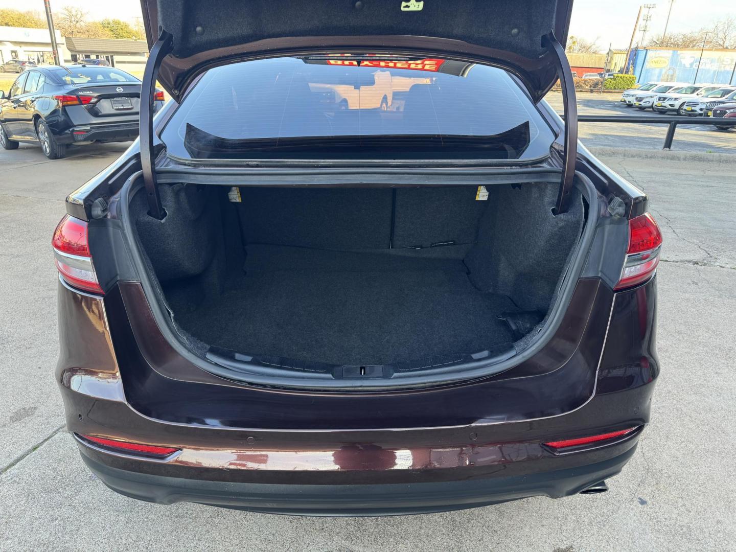 2019 BROWN FORD FUSION SE SE (3FA6P0HD5KR) with an 1.5L engine, 6-Speed Automatic transmission, located at 5900 E. Lancaster Ave., Fort Worth, TX, 76112, (817) 457-5456, 0.000000, 0.000000 - The 2019 Ford Fusion SE delivers efficiency and comfort with its 1.5L EcoBoost engine offering up to 34 MPG highway. Features include Bluetooth, backup camera, alloy wheels, and seating for five. A reliable sedan with modern technology and great fuel economy - Photo#5