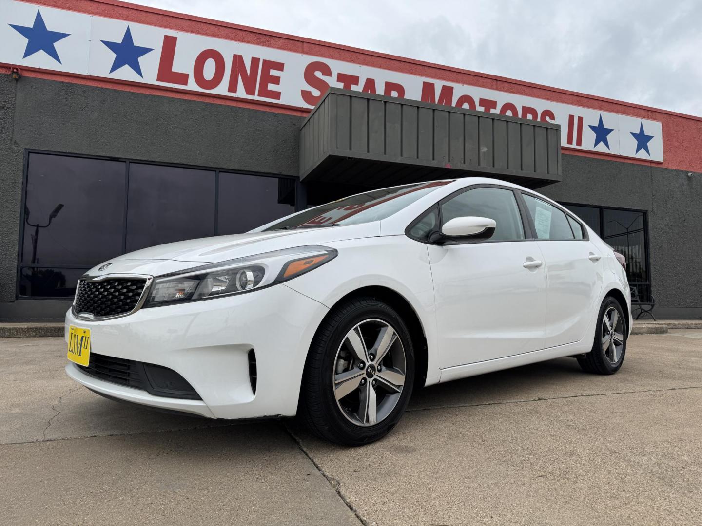 2018 WHITE /BLACK KIA FORTE LX; S LX (3KPFL4A70JE) with an 2.0L engine, 6-Speed Automatic transmission, located at 5900 E. Lancaster Ave., Fort Worth, TX, 76112, (817) 457-5456, 0.000000, 0.000000 - The 2018 Kia Forte LX combines efficiency and comfort with a 2.0L 4-cylinder engine, 6-speed automatic transmission, and impressive 29 city / 37 highway MPG. It seats five with spacious legroom and features a backup camera, phone connectivity, 4-wheel ABS disc brakes, and coil spring suspension. A r - Photo#0