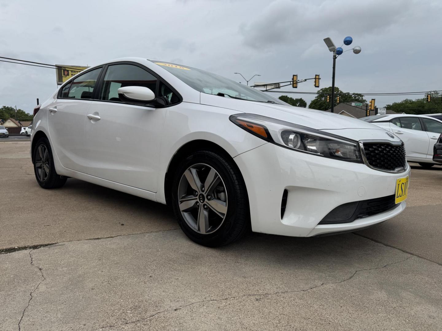 2018 WHITE /BLACK KIA FORTE LX; S LX (3KPFL4A70JE) with an 2.0L engine, 6-Speed Automatic transmission, located at 5900 E. Lancaster Ave., Fort Worth, TX, 76112, (817) 457-5456, 0.000000, 0.000000 - The 2018 Kia Forte LX combines efficiency and comfort with a 2.0L 4-cylinder engine, 6-speed automatic transmission, and impressive 29 city / 37 highway MPG. It seats five with spacious legroom and features a backup camera, phone connectivity, 4-wheel ABS disc brakes, and coil spring suspension. A r - Photo#2