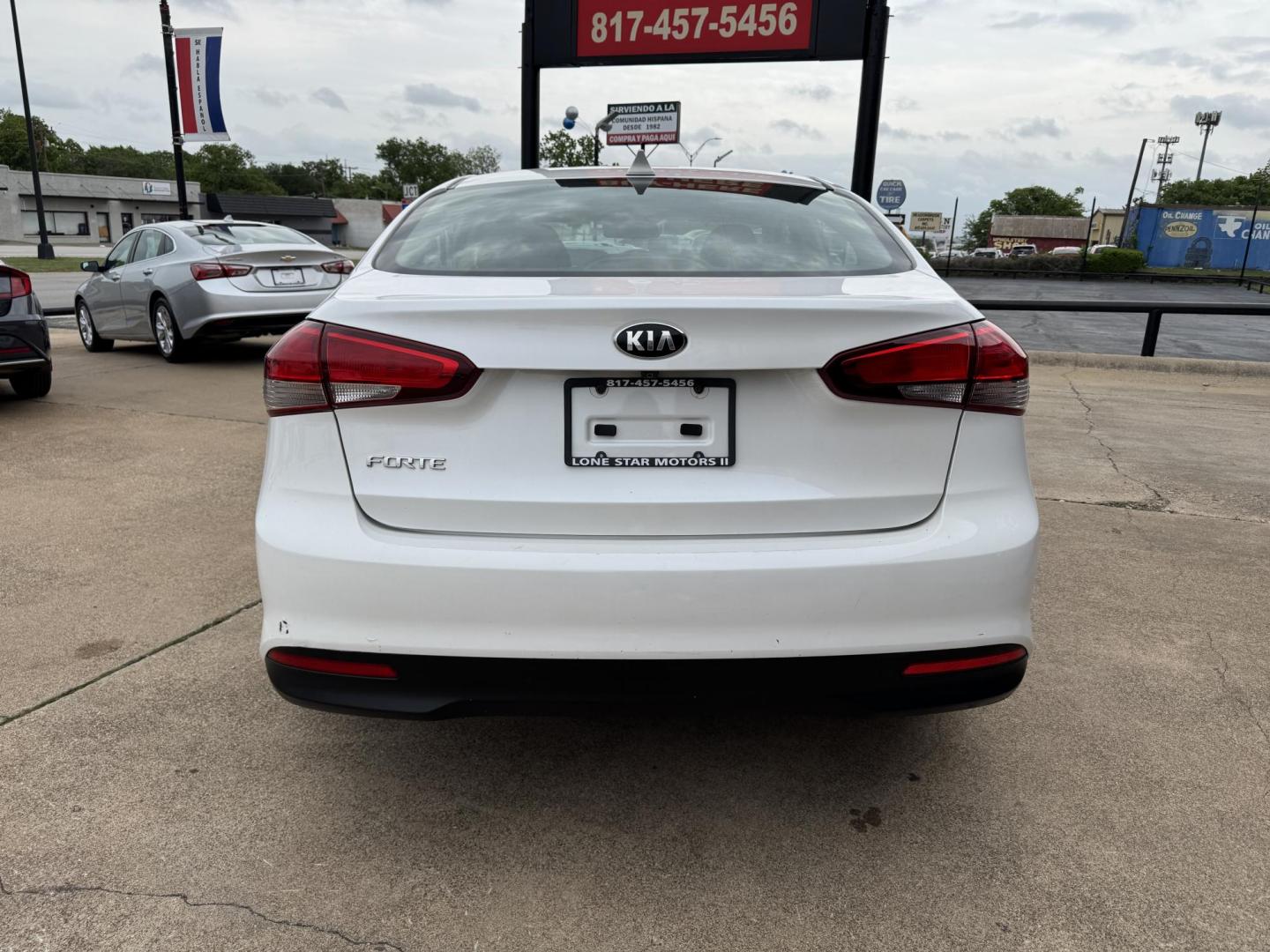 2018 WHITE /BLACK KIA FORTE LX; S LX (3KPFL4A70JE) with an 2.0L engine, 6-Speed Automatic transmission, located at 5900 E. Lancaster Ave., Fort Worth, TX, 76112, (817) 457-5456, 0.000000, 0.000000 - The 2018 Kia Forte LX combines efficiency and comfort with a 2.0L 4-cylinder engine, 6-speed automatic transmission, and impressive 29 city / 37 highway MPG. It seats five with spacious legroom and features a backup camera, phone connectivity, 4-wheel ABS disc brakes, and coil spring suspension. A r - Photo#4