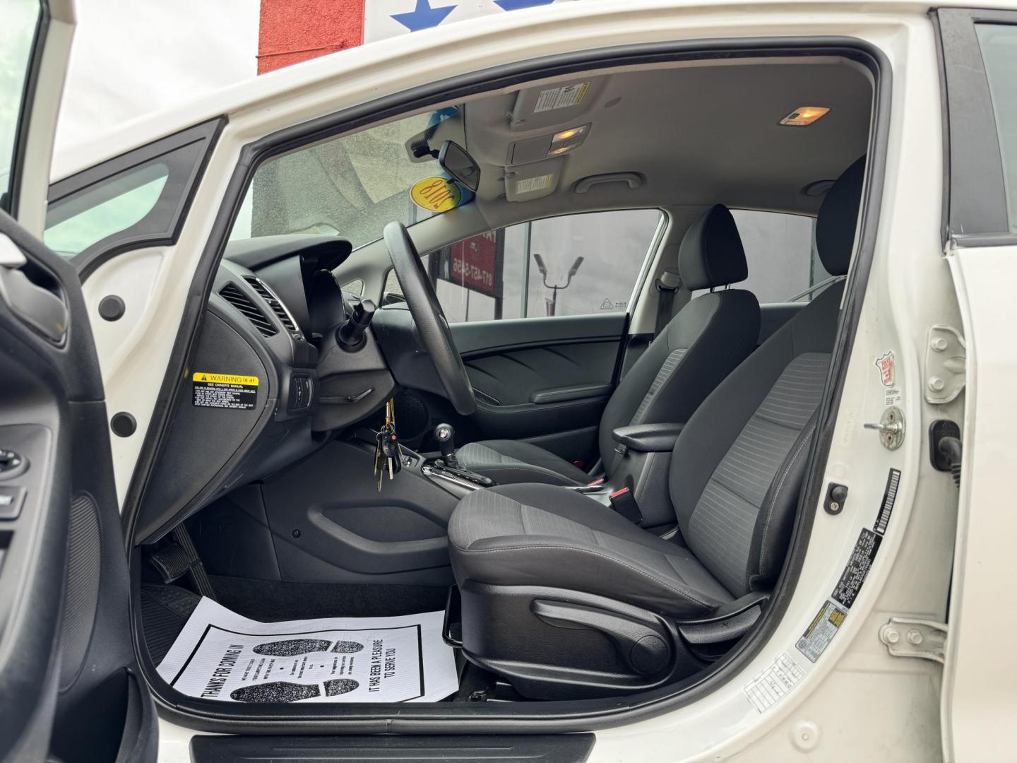 2018 WHITE /BLACK KIA FORTE LX; S LX (3KPFL4A70JE) with an 2.0L engine, 6-Speed Automatic transmission, located at 5900 E. Lancaster Ave., Fort Worth, TX, 76112, (817) 457-5456, 0.000000, 0.000000 - The 2018 Kia Forte LX combines efficiency and comfort with a 2.0L 4-cylinder engine, 6-speed automatic transmission, and impressive 29 city / 37 highway MPG. It seats five with spacious legroom and features a backup camera, phone connectivity, 4-wheel ABS disc brakes, and coil spring suspension. A r - Photo#8