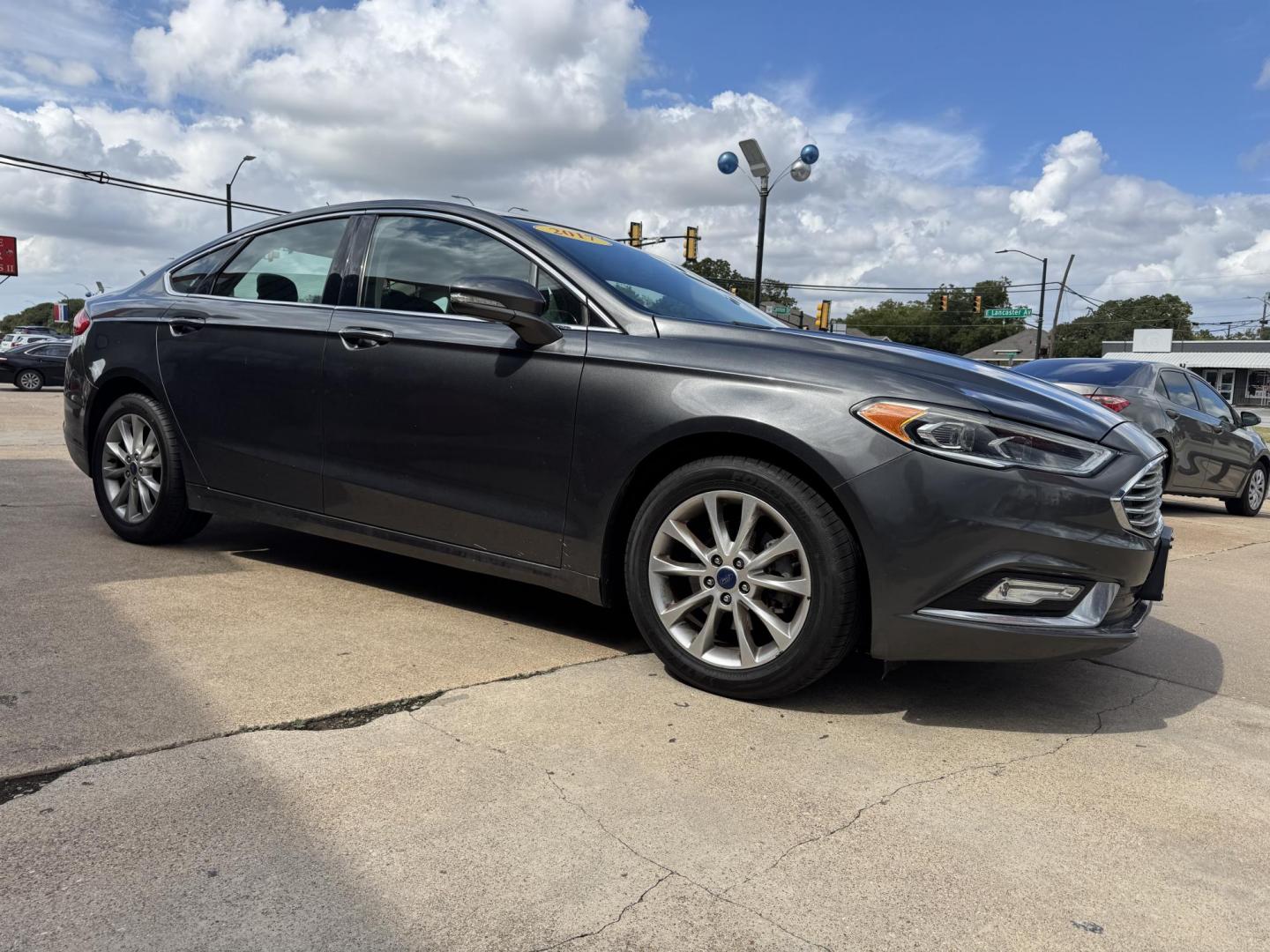 2017 GRAY /BLACK FORD FUSION SE SE (3FA6P0HD2HR) with an 1.5L engine, 6-Speed Automatic transmission, located at 5900 E. Lancaster Ave., Fort Worth, TX, 76112, (817) 457-5456, 0.000000, 0.000000 - The 2017 Ford Fusion SE offers a perfect mix of style and efficiency with its 1.5L 4-cylinder engine and 6-speed automatic transmission, delivering 22 city / 34 highway MPG. This FWD sedan seats five comfortably and comes equipped with backup camera, phone connectivity, alloy wheels, and dual climat - Photo#2