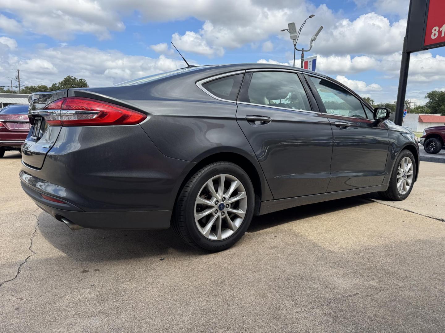 2017 GRAY /BLACK FORD FUSION SE SE (3FA6P0HD2HR) with an 1.5L engine, 6-Speed Automatic transmission, located at 5900 E. Lancaster Ave., Fort Worth, TX, 76112, (817) 457-5456, 0.000000, 0.000000 - The 2017 Ford Fusion SE offers a perfect mix of style and efficiency with its 1.5L 4-cylinder engine and 6-speed automatic transmission, delivering 22 city / 34 highway MPG. This FWD sedan seats five comfortably and comes equipped with backup camera, phone connectivity, alloy wheels, and dual climat - Photo#3