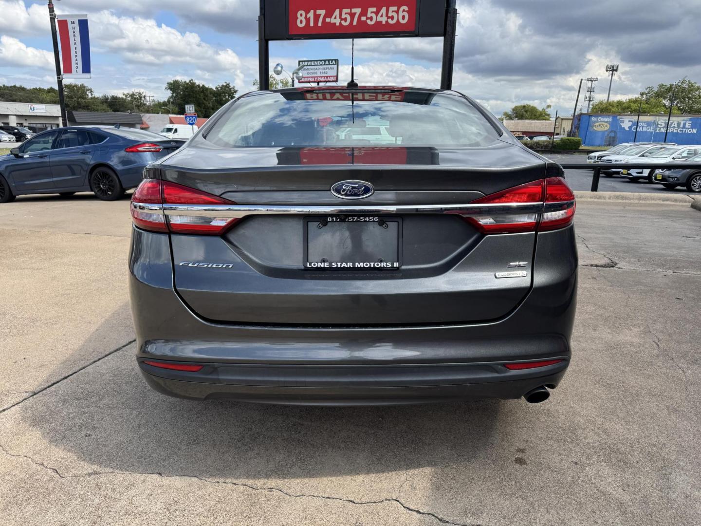 2017 GRAY /BLACK FORD FUSION SE SE (3FA6P0HD2HR) with an 1.5L engine, 6-Speed Automatic transmission, located at 5900 E. Lancaster Ave., Fort Worth, TX, 76112, (817) 457-5456, 0.000000, 0.000000 - The 2017 Ford Fusion SE offers a perfect mix of style and efficiency with its 1.5L 4-cylinder engine and 6-speed automatic transmission, delivering 22 city / 34 highway MPG. This FWD sedan seats five comfortably and comes equipped with backup camera, phone connectivity, alloy wheels, and dual climat - Photo#4